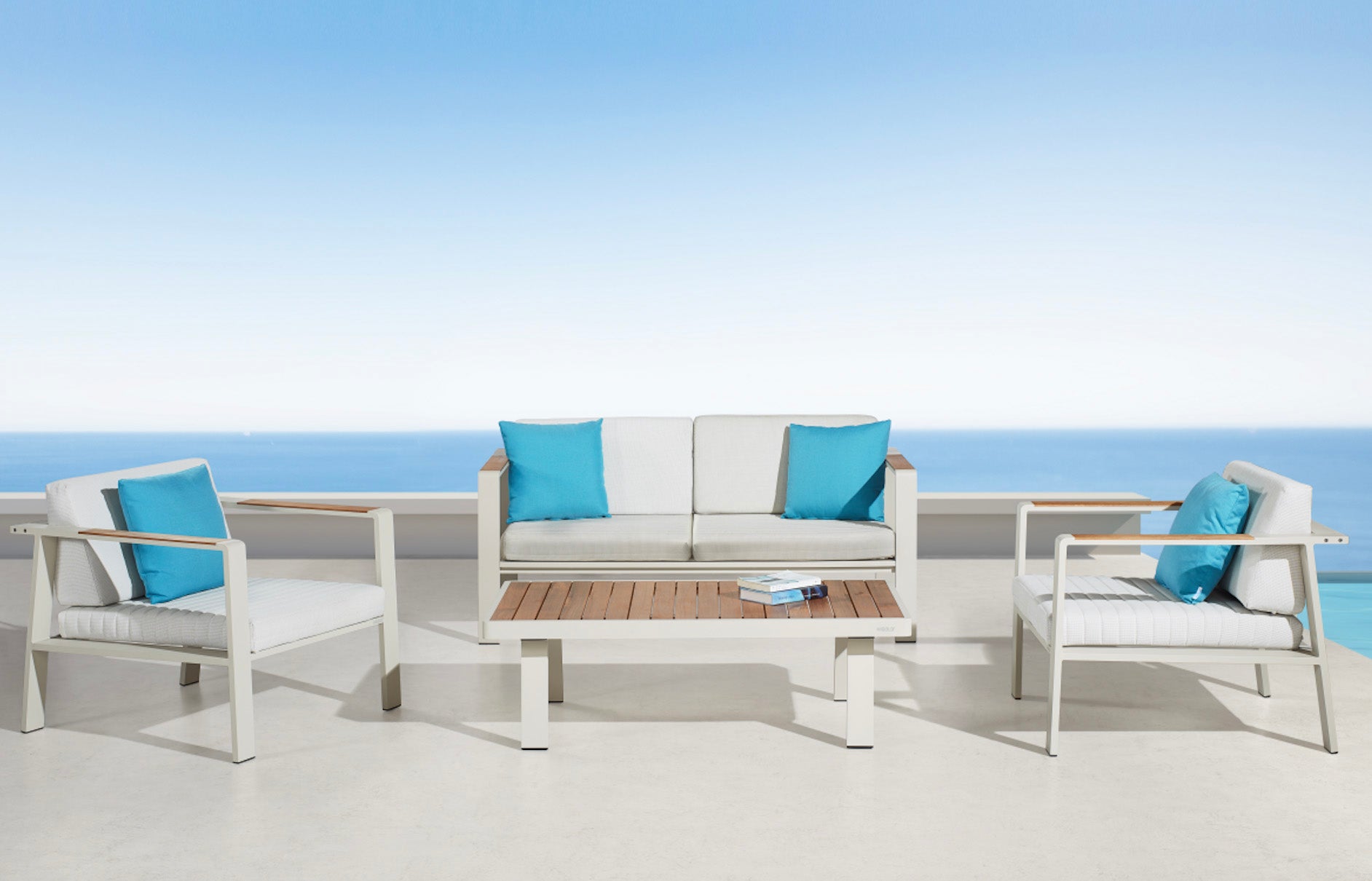 Salon de jardin luxe en aluminium haut de gamme blanc, coussins en tissu oléfine turquoise et beige, table en teck FSC.