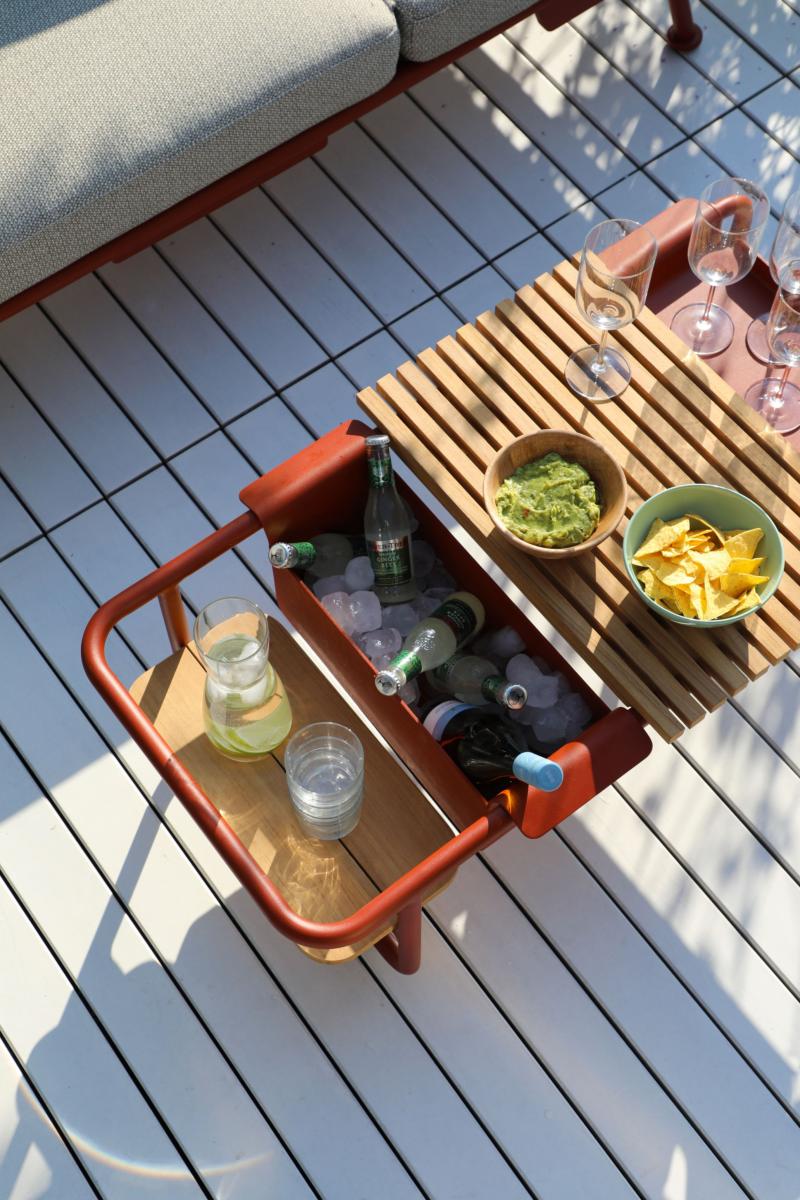 Table basse en aluminium rouge de la collection modulable Sunny, design belge alliant luxe et innovation, espace intégré.