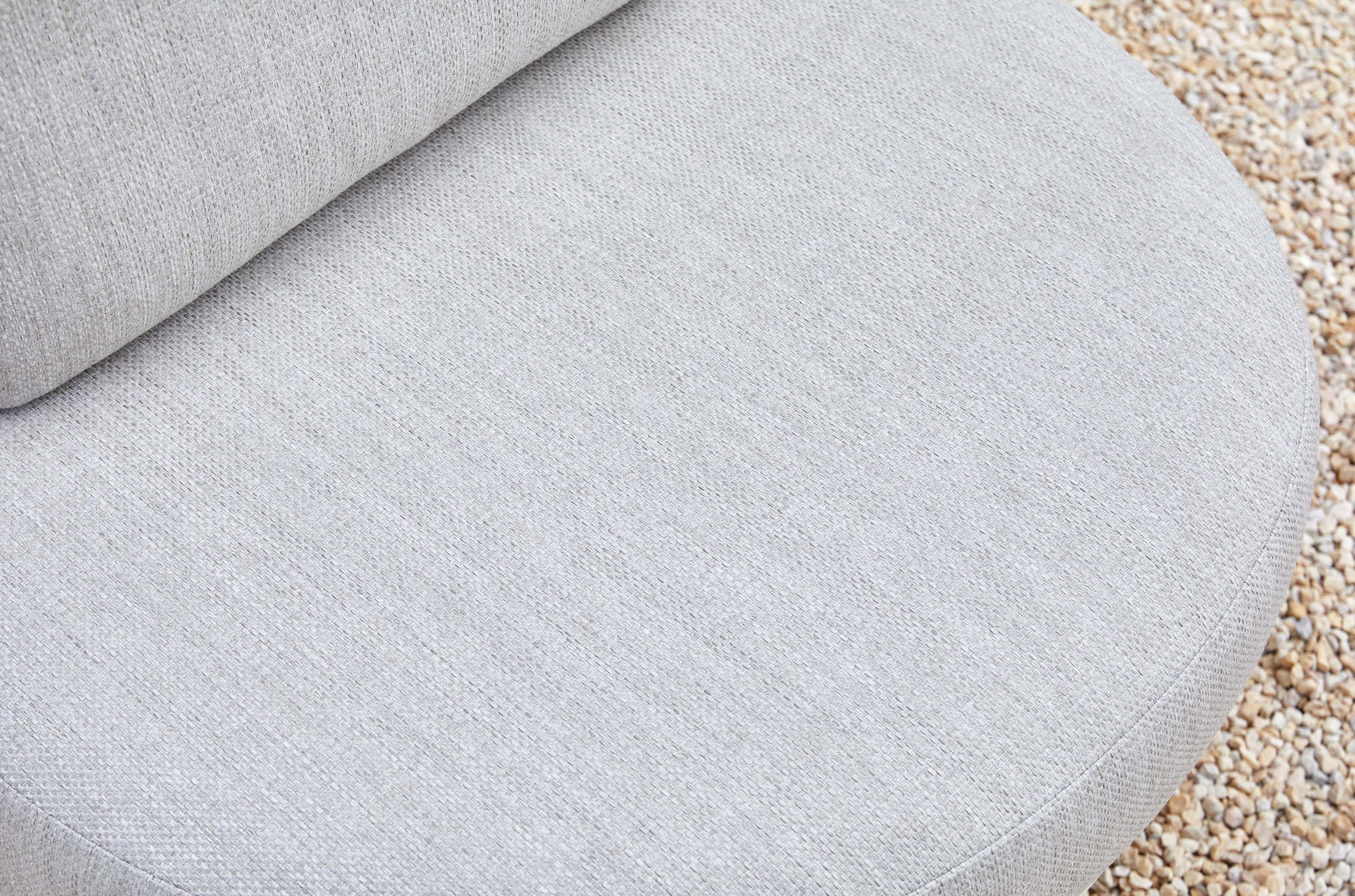 Coussin arrondi en tissu oléfine gris clair, mousse Quick Dry Foam pour confort et durabilité, housse déperlante. 